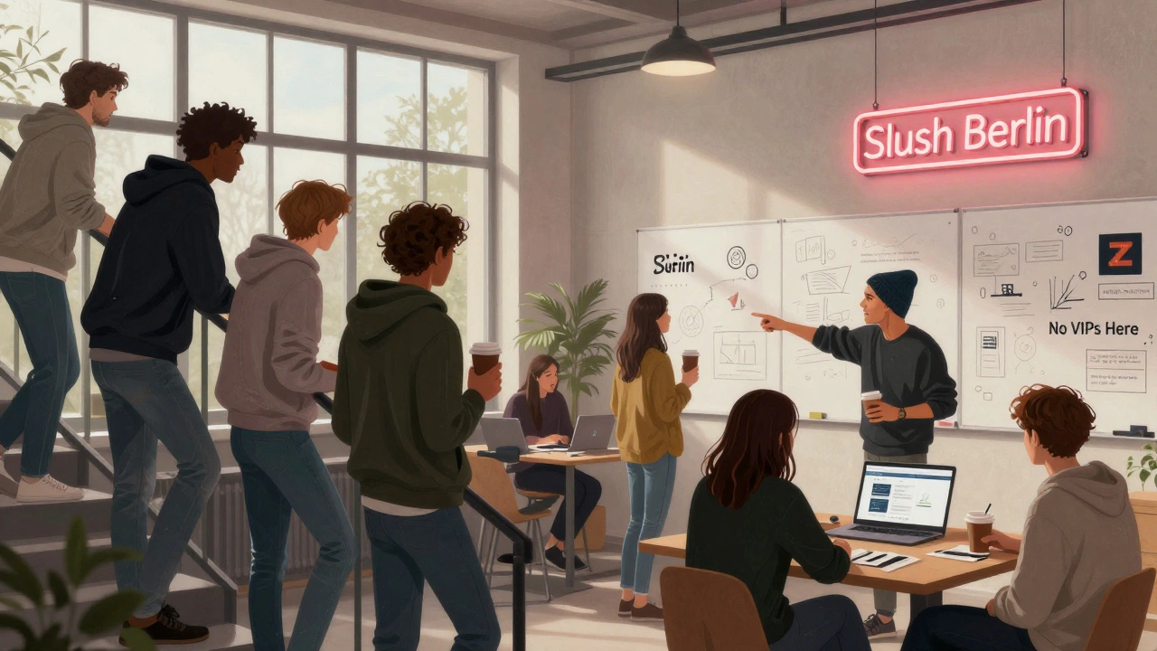 Участники конференции в Берлине разговаривают у кофемашины, на стенах — чертежи стартапов.